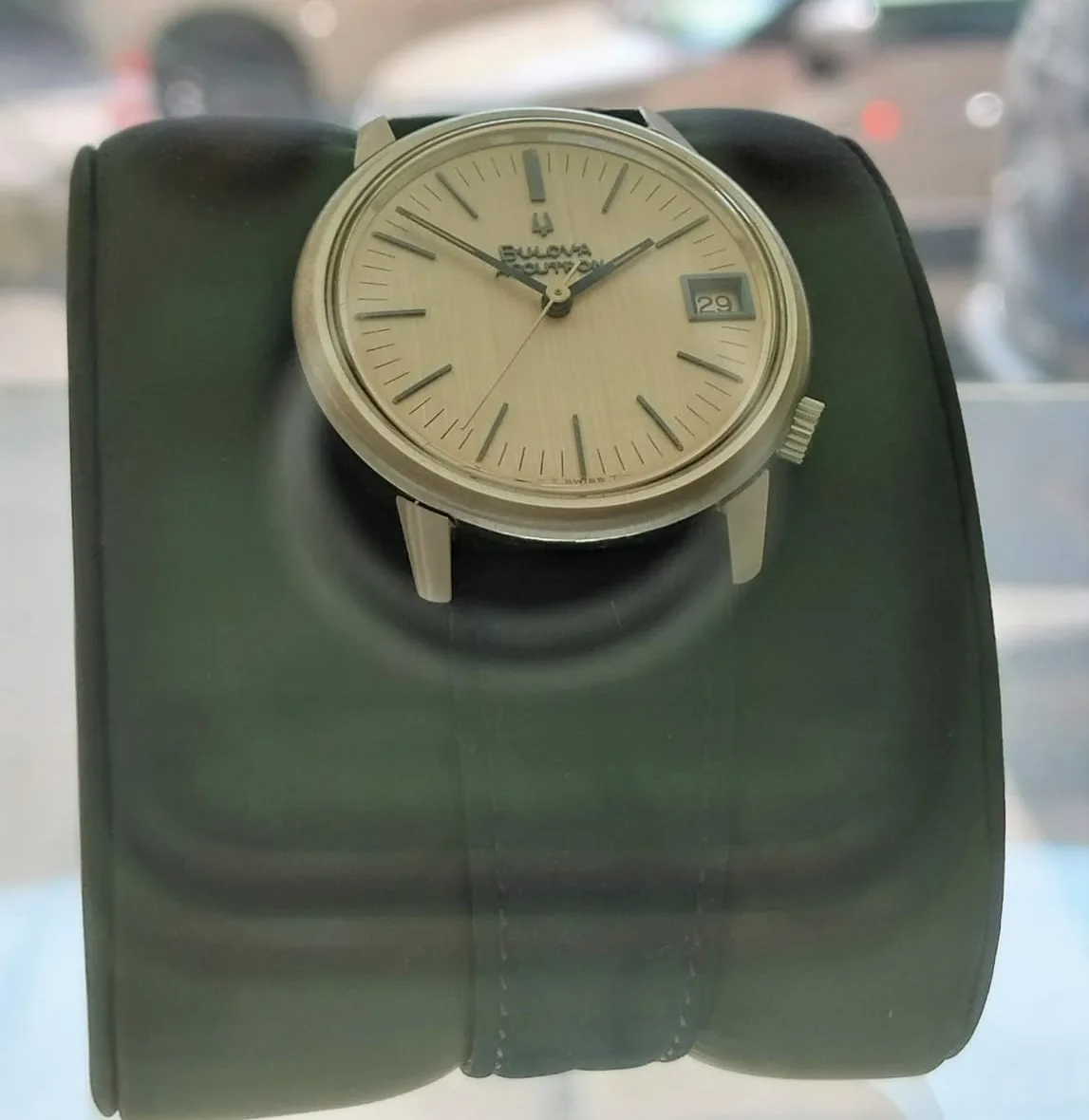 Bulova Accutron calibre 218 with a closed silver dial and a tuning-fork emblem, off the wrist on a white ground