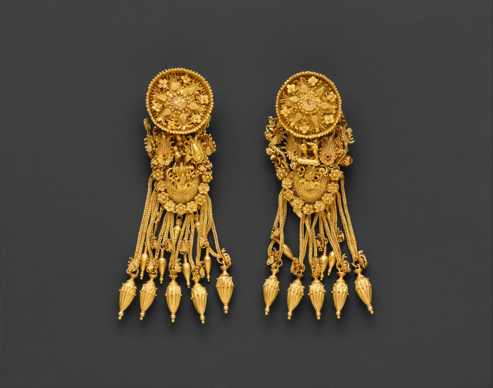 Pair of Hellenistic gold earrings with a floral disk above a boat-shaped pendant and hanging chains