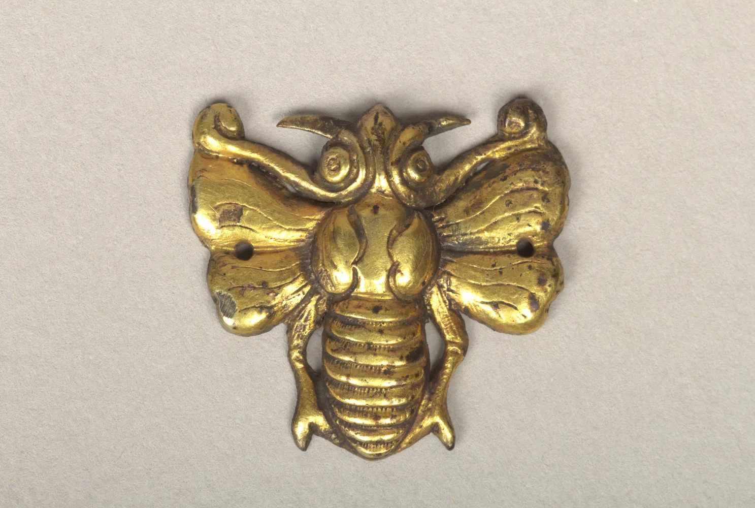 Goryeo gold ornament shaped as a bee with scalloped veined wings, four legs, and two sew-holes