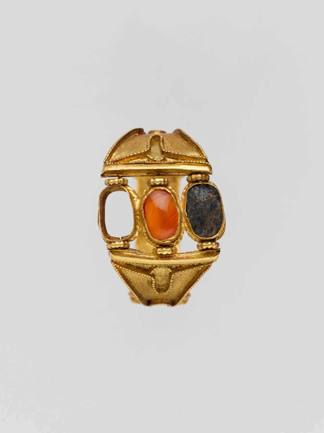 Cypriot gold ring with three raised box settings on the bezel and cloison walls along the sides