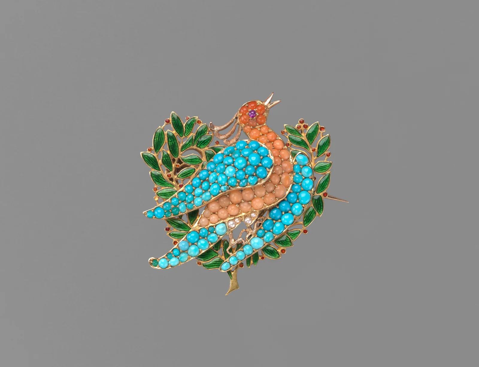 Gold brooch of a dove with coral and turquoise plumage perched among enameled olive leaves