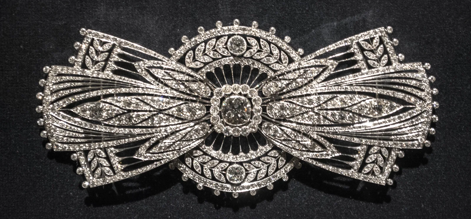 Boucheron platinum and diamond bow-tie brooch with a radiating circular center and two diamond wings