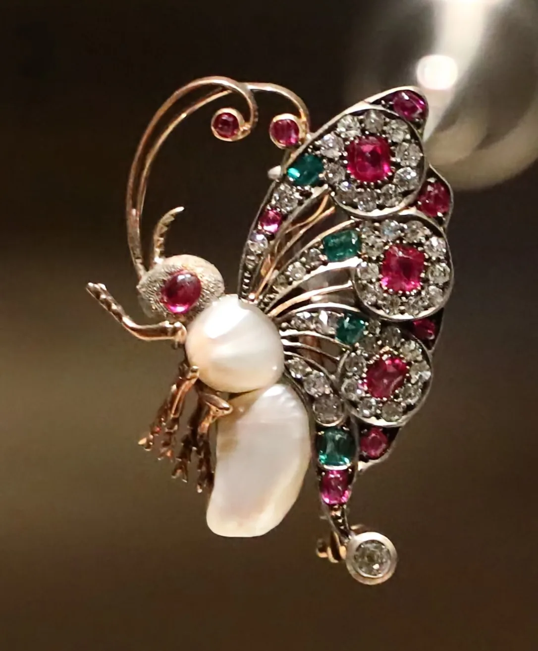 French butterfly brooch in profile with two Gulf pearls for a body and a gem-set wing