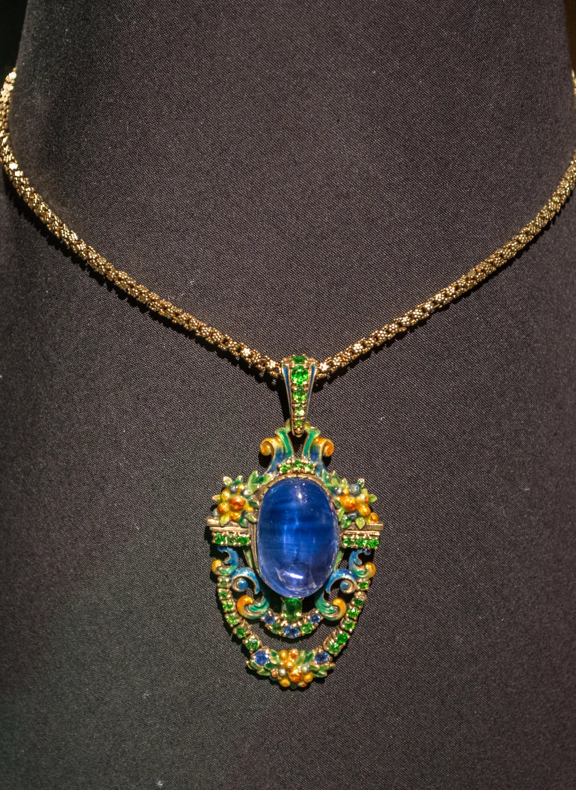 Meta Overbeck for Tiffany necklace with a large oval cabochon sapphire in a gold and enamel frame on a bust