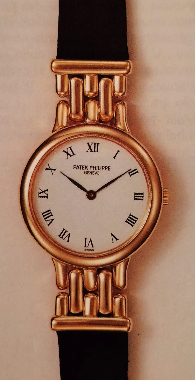 Patek Philippe Calatrava Lady reference 3915 from the early 1990s, a small round case with a stone-set bezel, shown off the wrist on a white ground
