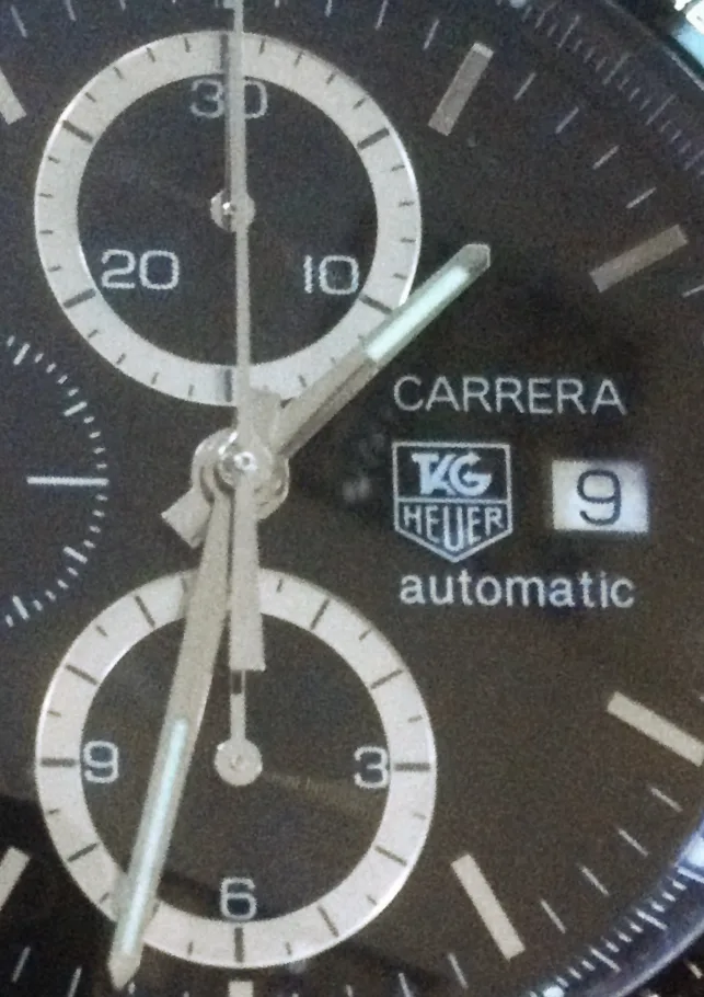 TAG Heuer Carrera chronograph reference CV2010 with a black dial, subdials, and a tachymeter, shown off the wrist on a white ground