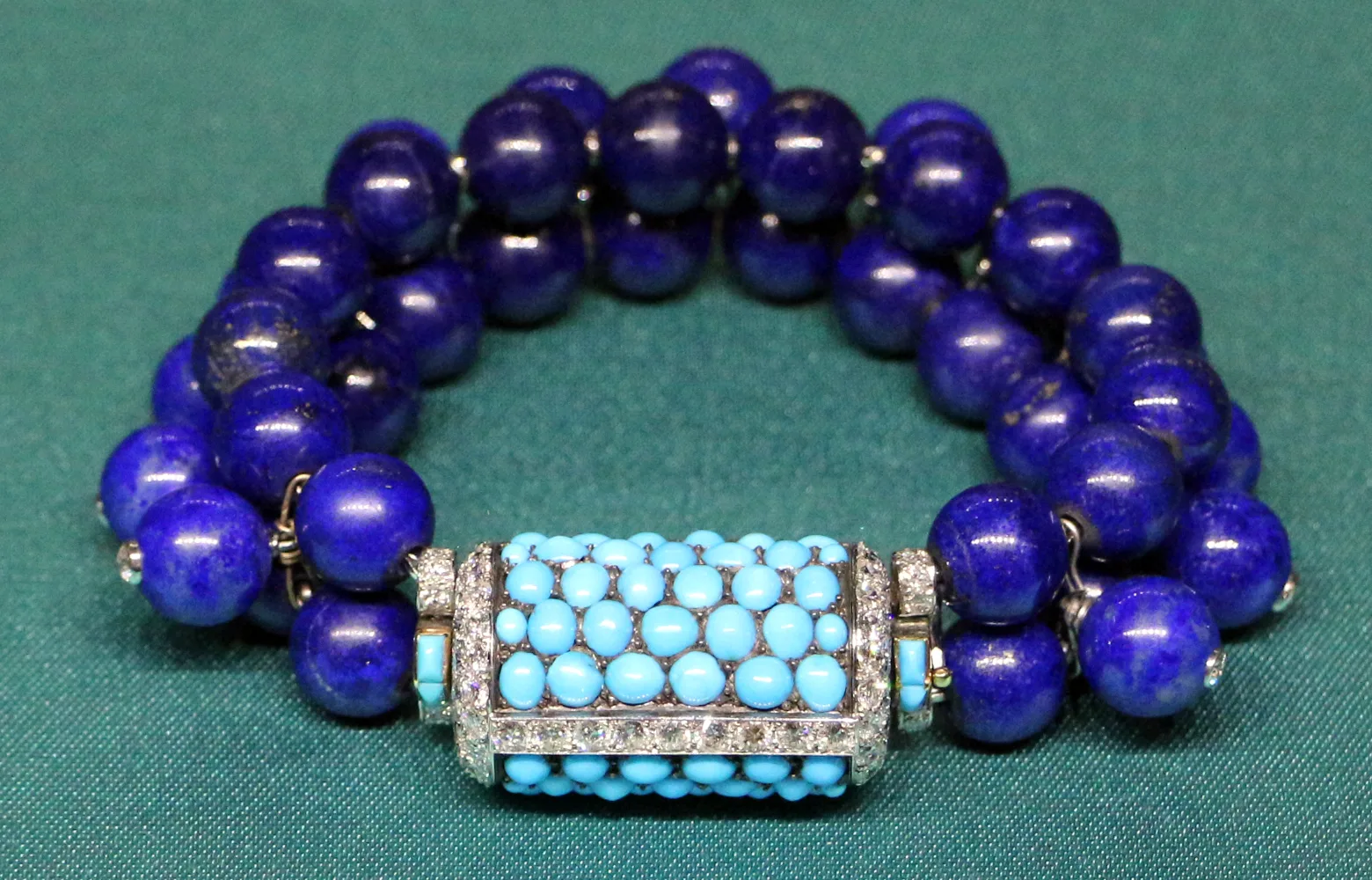 Cartier bracelet of lapis lazuli beads with a turquoise and diamond drum clasp, 1937