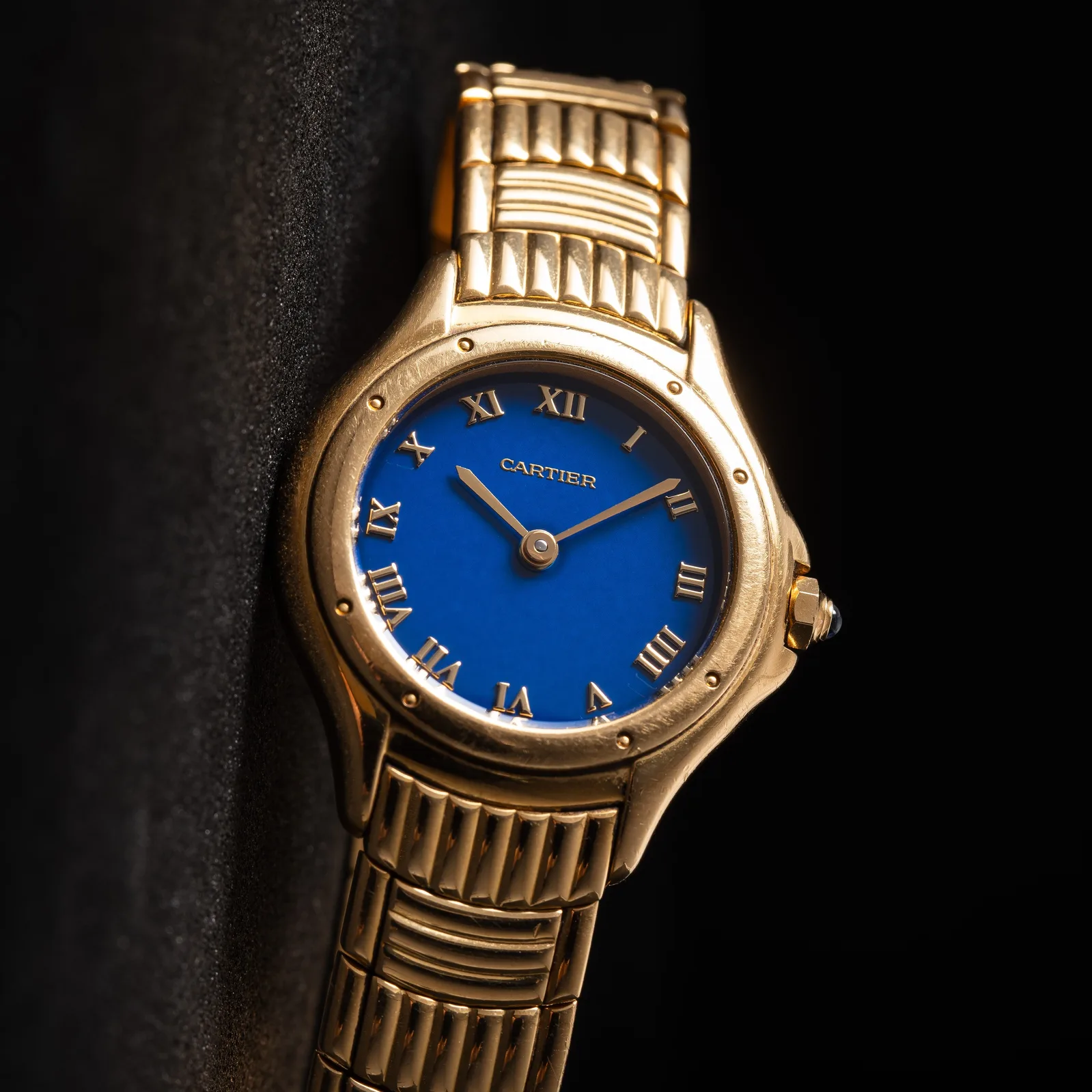 Yellow-gold Cartier Cougar with a lapis lazuli dial, Roman numerals, and a brick-link bracelet