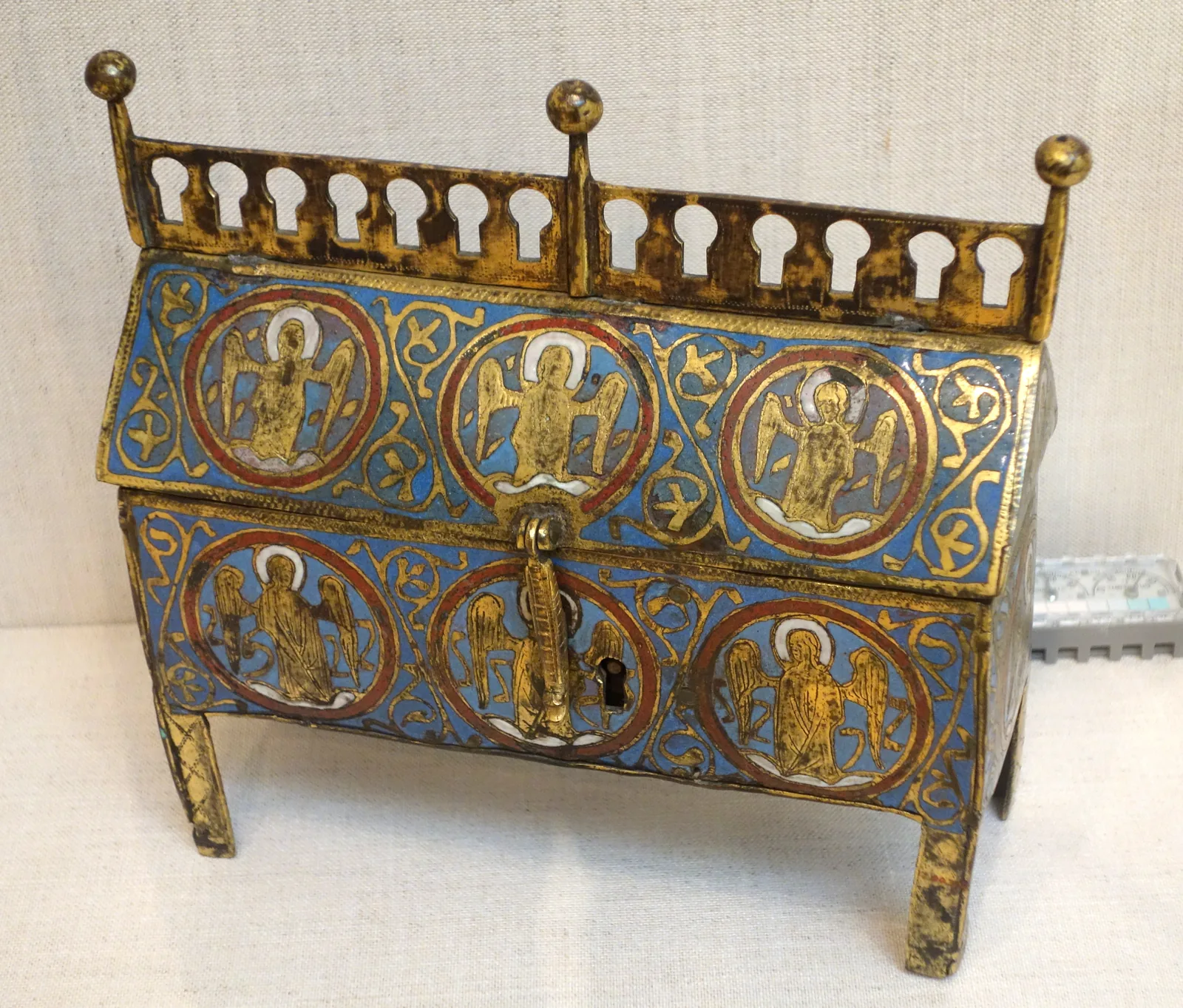 A Limoges chasse with angel medallions in gilt copper and champlevé enamel, on a white ground