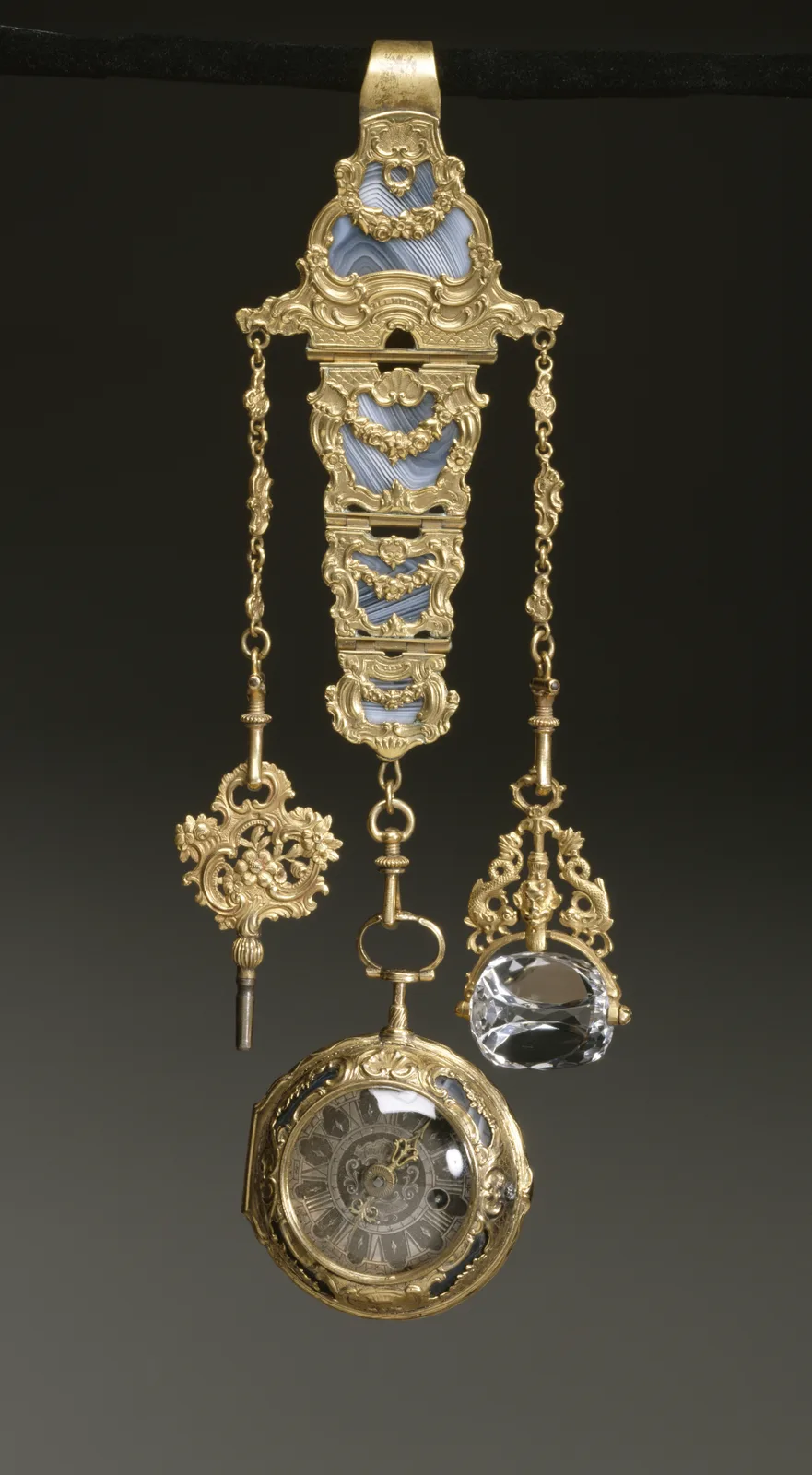 An eighteenth-century French chatelaine of gold and agate, with a hook at the top, linked panels, and a watch at the bottom