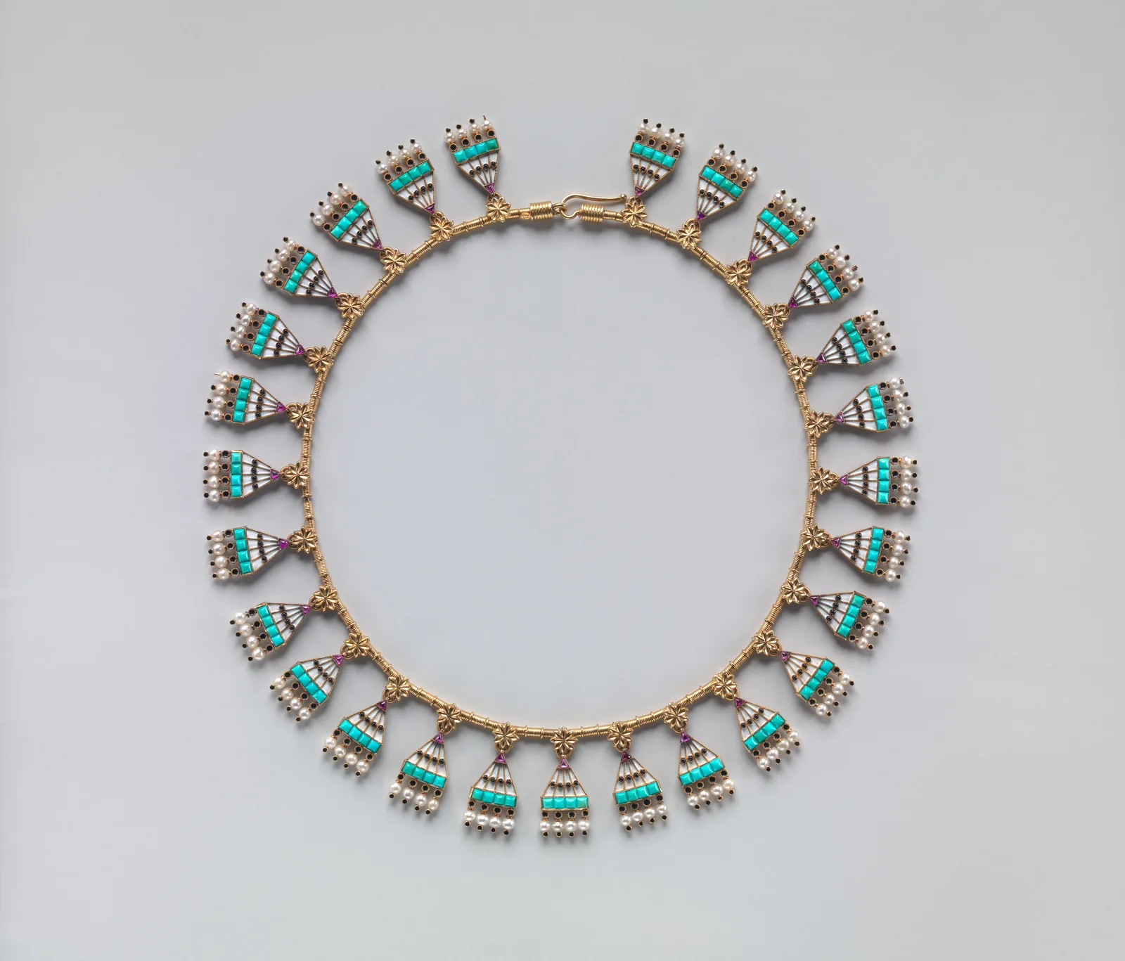 Egyptian Revival gold collar of fan pendants with turquoise squares, white enamel, rubies, and seed pearls