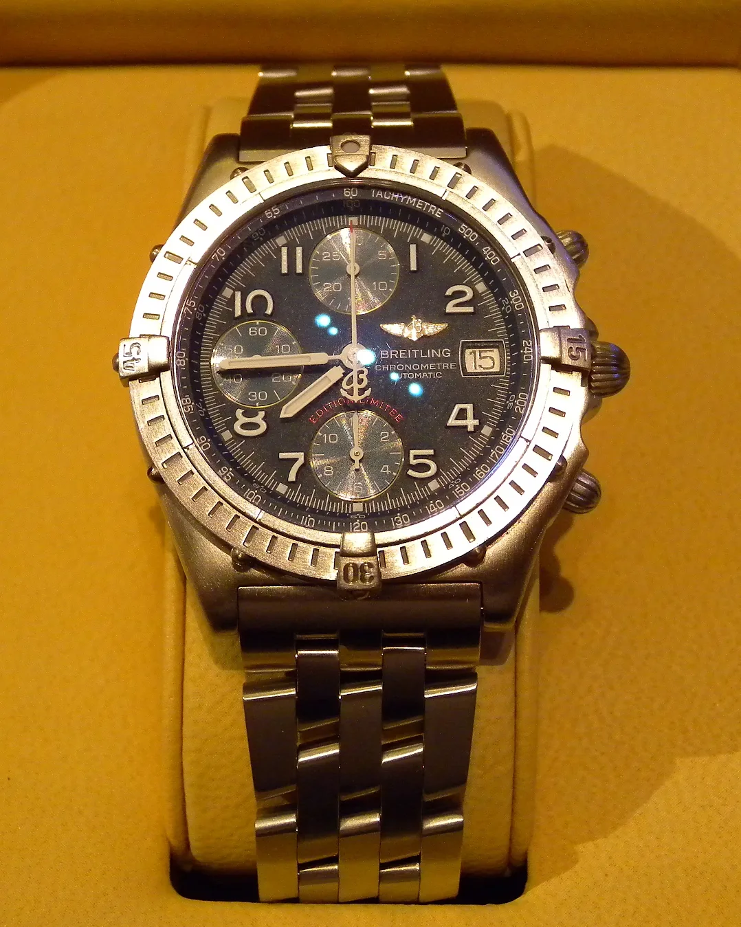 A steel Breitling Chronomat Bluebird with a black dial and four bezel tabs, shown off the wrist