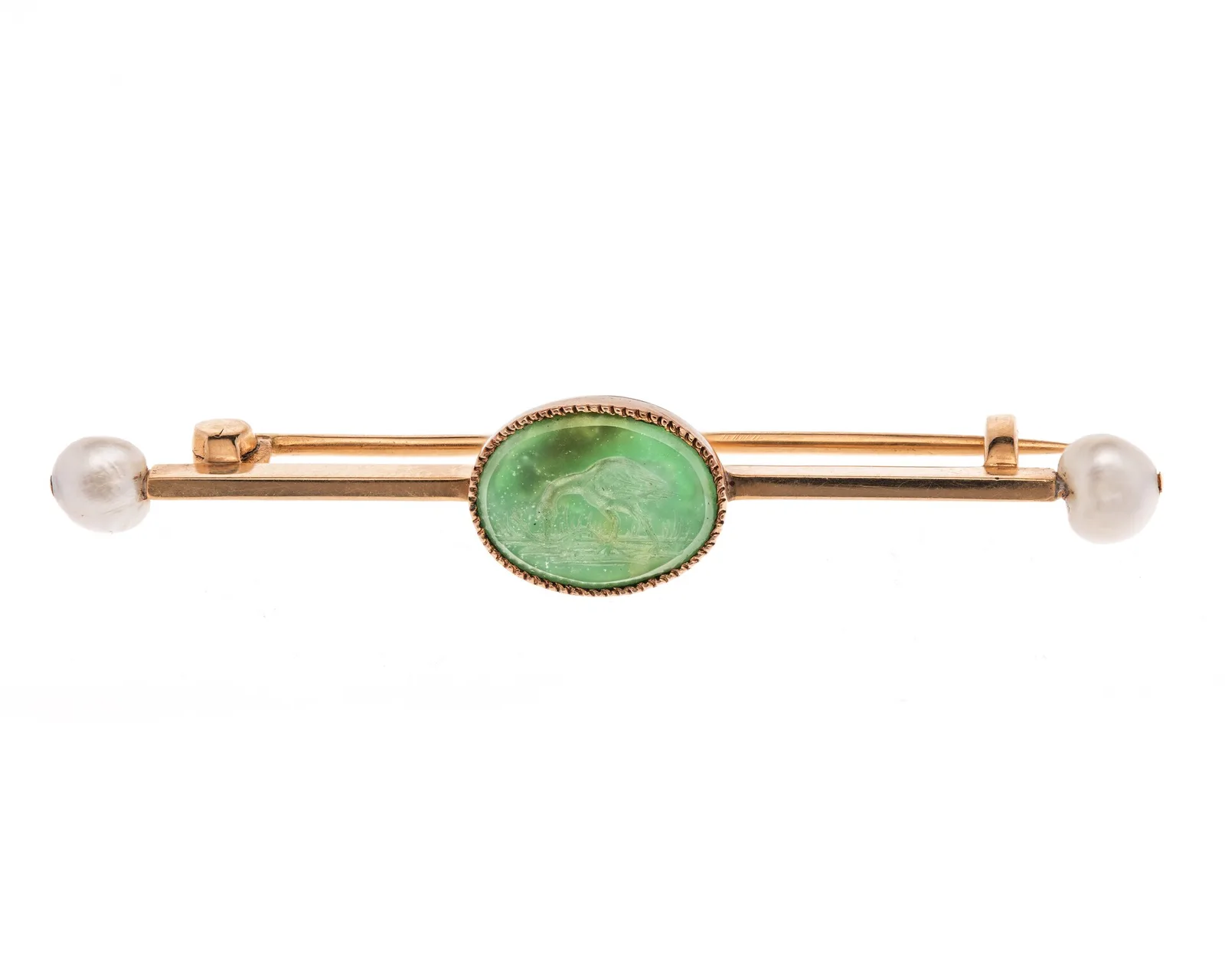 Gold bar brooch with a central oval chrysoprase carved with a stork, and a pearl at each end of the pin