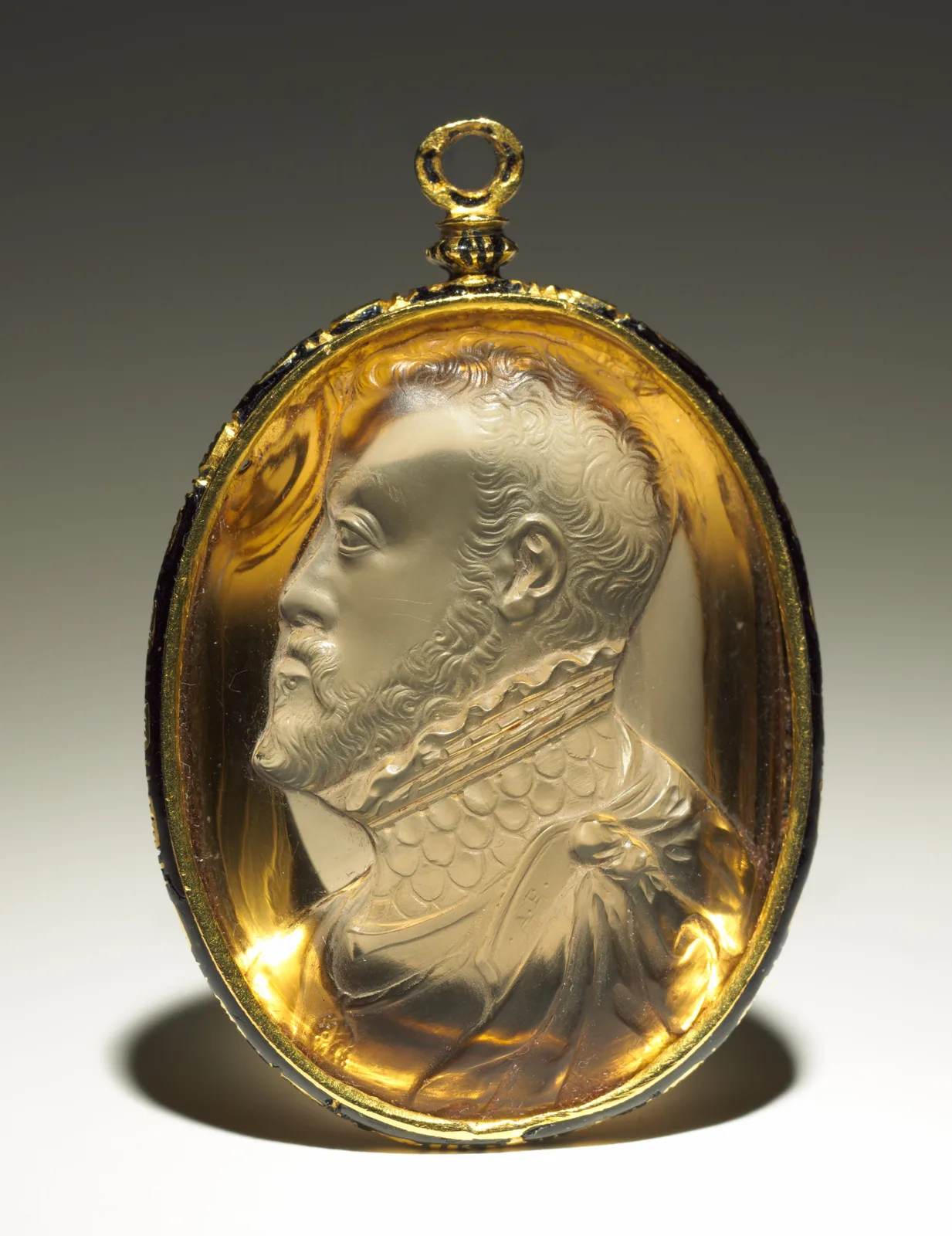 Oval citrine pendant carved in profile as Philip II, the honey-yellow stone glowing through a thin gold rim