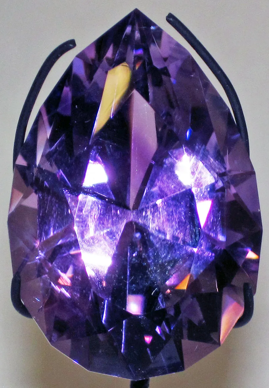 Large faceted amethyst seen from above, the table at the center and the surrounding crown facets stepping outward