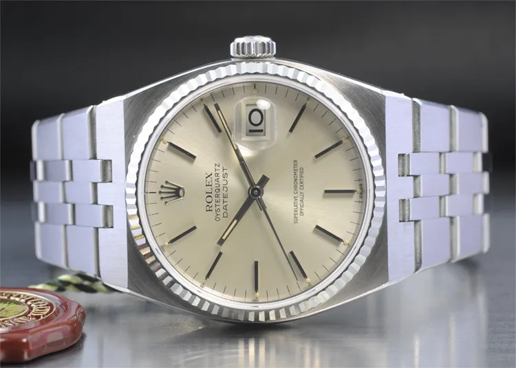 Rolex Oysterquartz Datejust with a champagne dial, fluted bezel, and integrated bracelet