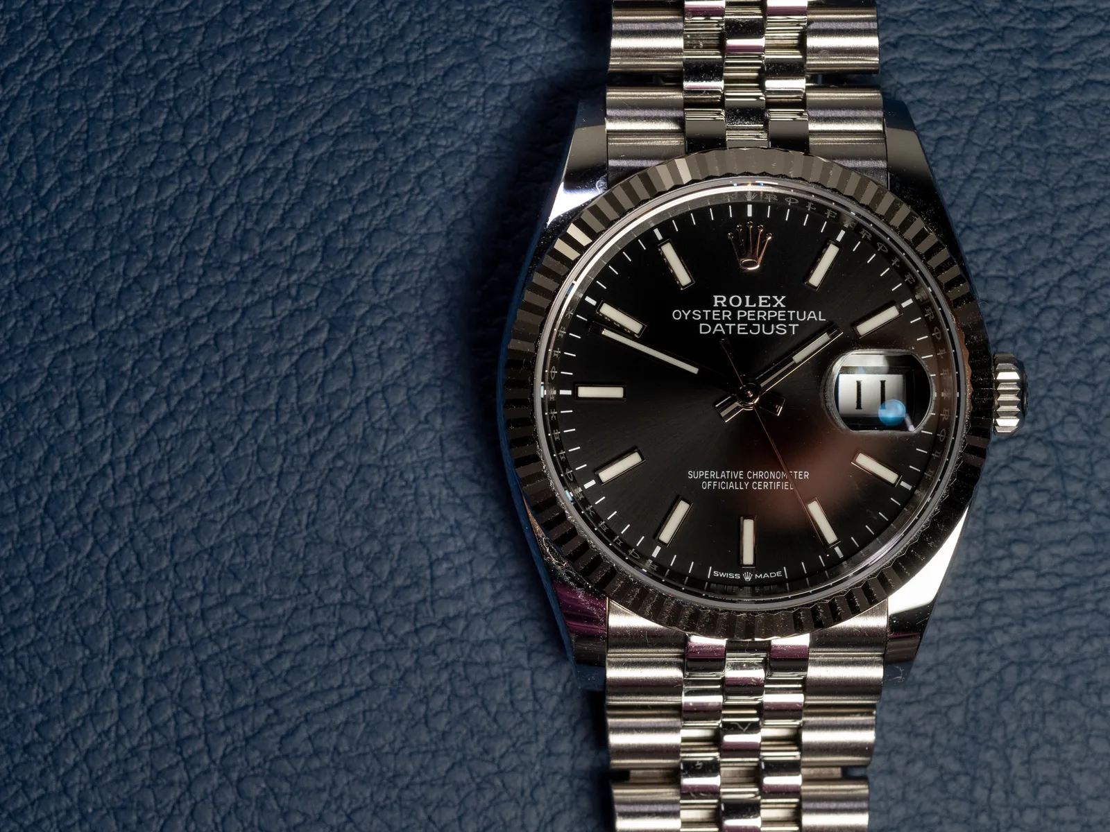 Steel Rolex Datejust 36 with a black sunburst dial, fluted bezel, and Jubilee bracelet