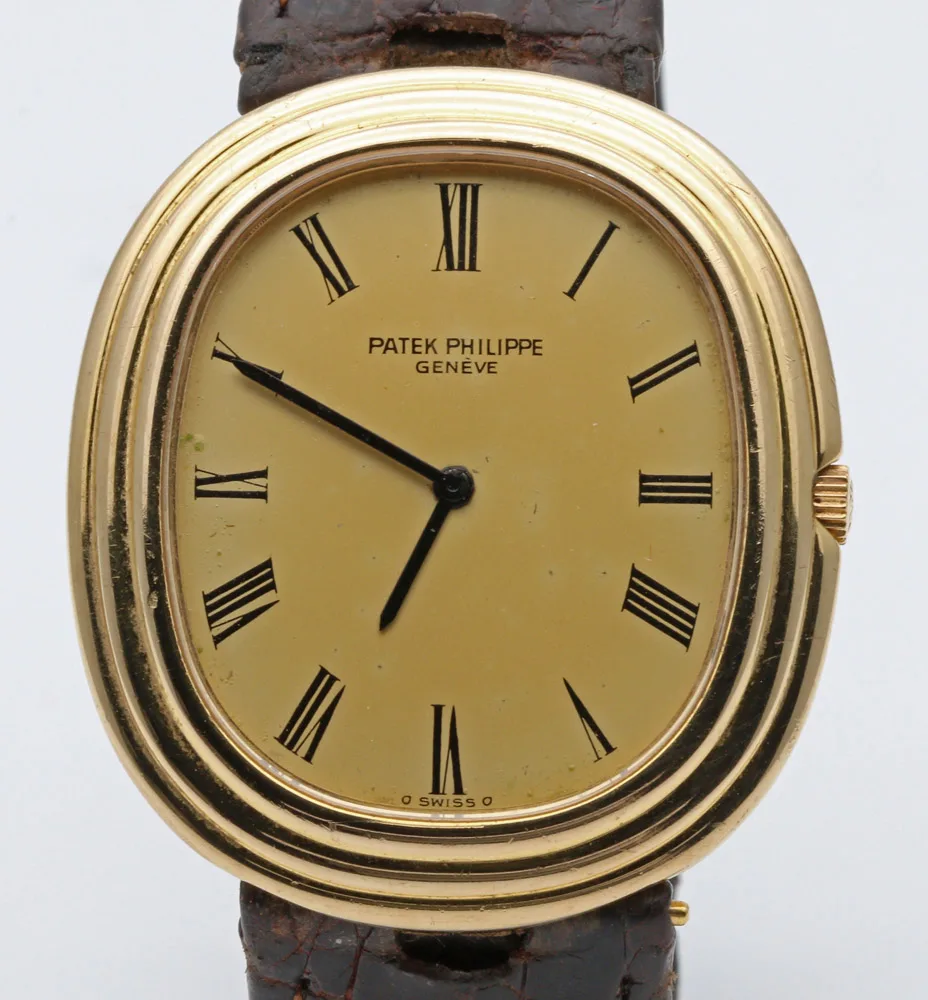 Patek Philippe Ellipse reference 3634 in yellow gold with a blue sunburst dial and a black strap, shown off the wrist
