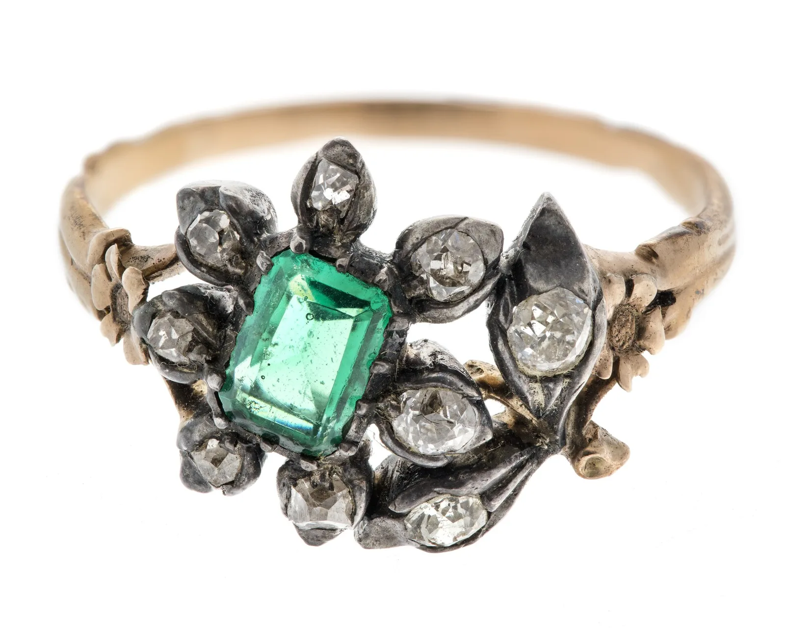 Eighteenth-century gold ring with a rectangular emerald-cut emerald, corners clipped, and old-cut diamonds as a small leafy spray