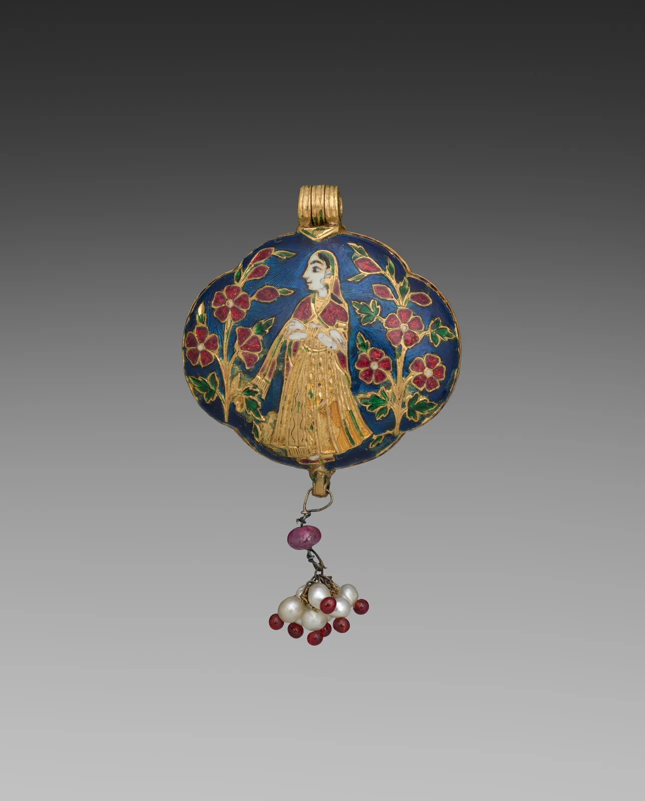 Jaipur gold locket with a painted-enamel figure in a yellow skirt against cobalt blue, red flowers at the sides, and a ruby-and-pearl drop