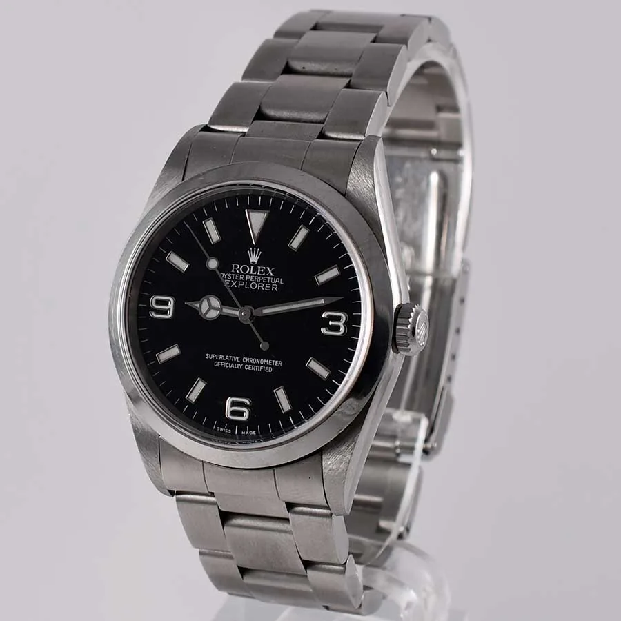 Rolex Explorer reference 14270 with a black dial and numerals at 3, 6, and 9, shown off the wrist on a white cushion