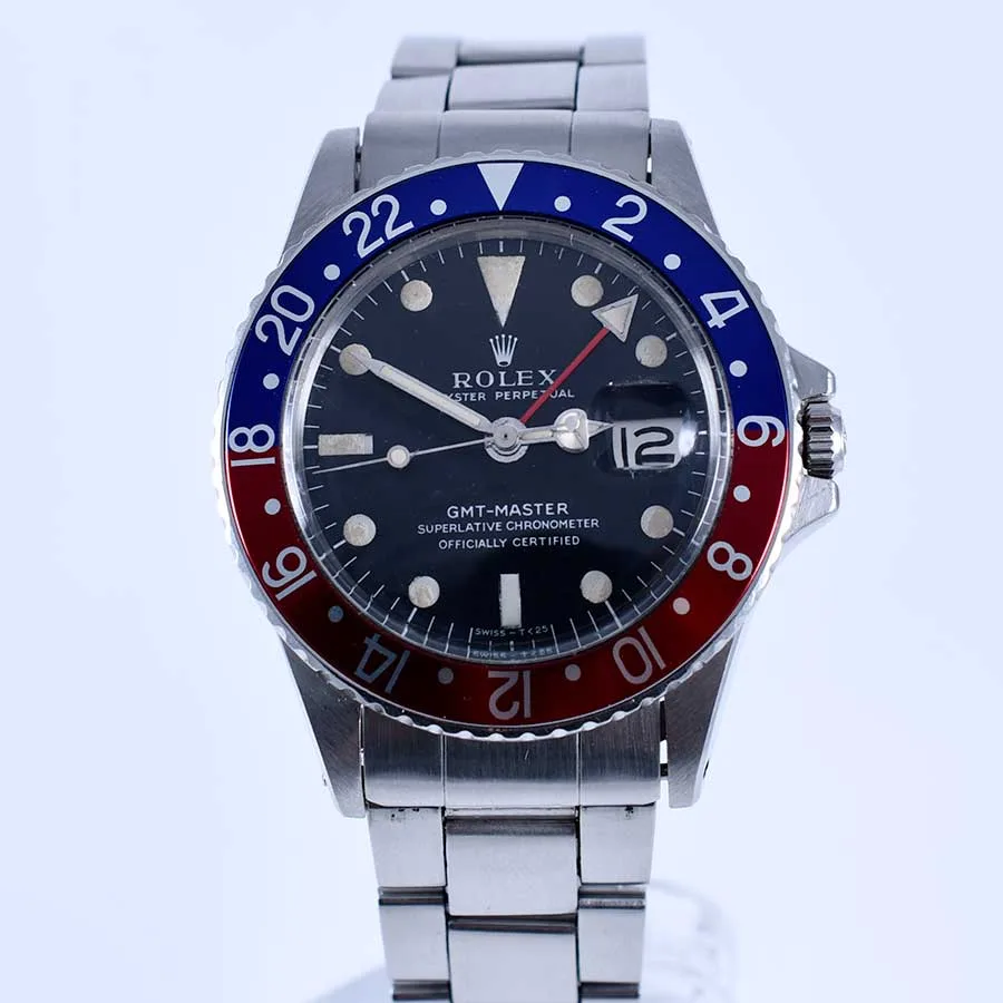 Steel Rolex GMT-Master reference 1675 with a blue and red Pepsi bezel, shown off the wrist in a display case