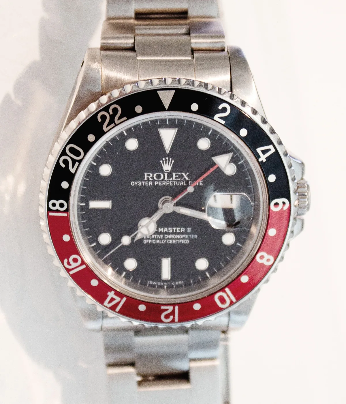 Rolex GMT-Master II with a blue and red bezel, shown off the wrist in a museum display case