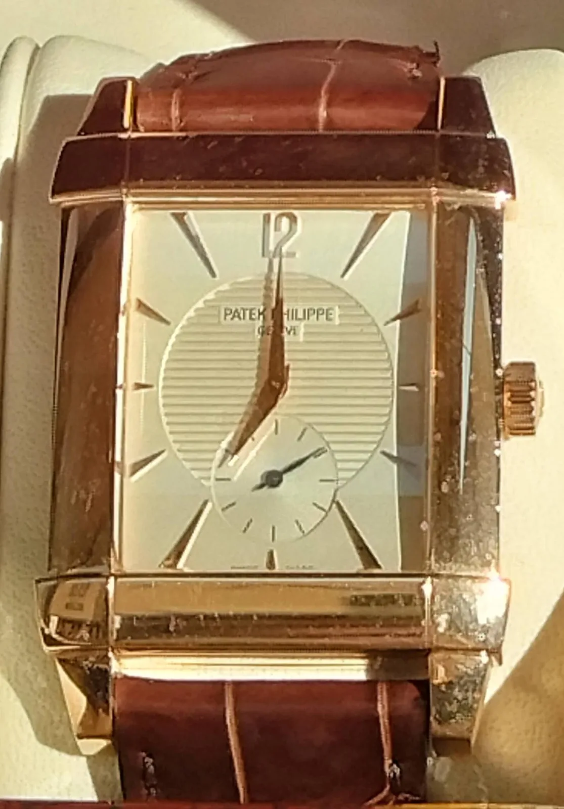 Rose-gold Patek Philippe Gondolo reference 5111R with a cream dial and curved rectangular case, shown off the wrist on a white ground