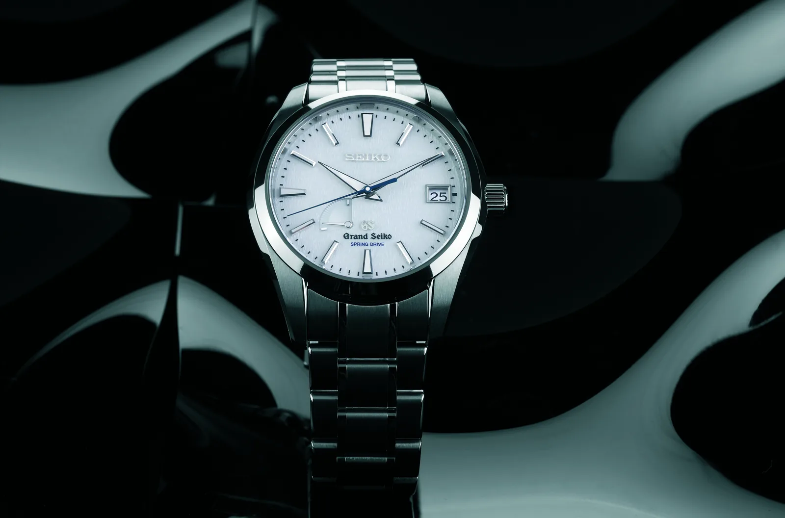 Grand Seiko Snowflake SBGA011 with a textured pale dial, shown off the wrist on a black ground