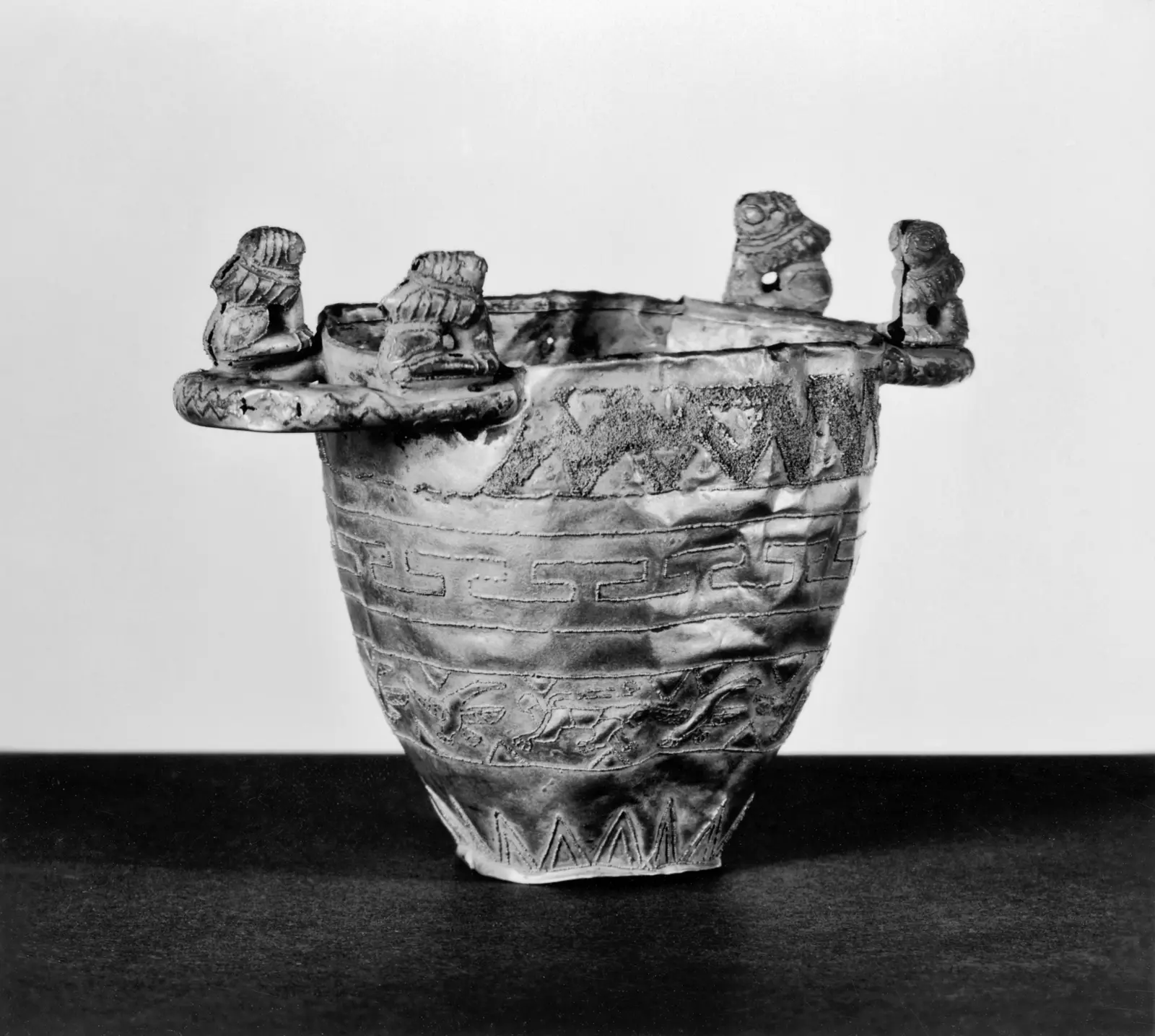 An Etruscan gold bowl covered in fine pulviscolo granulation, with birds, geometric bands, and a central rosette