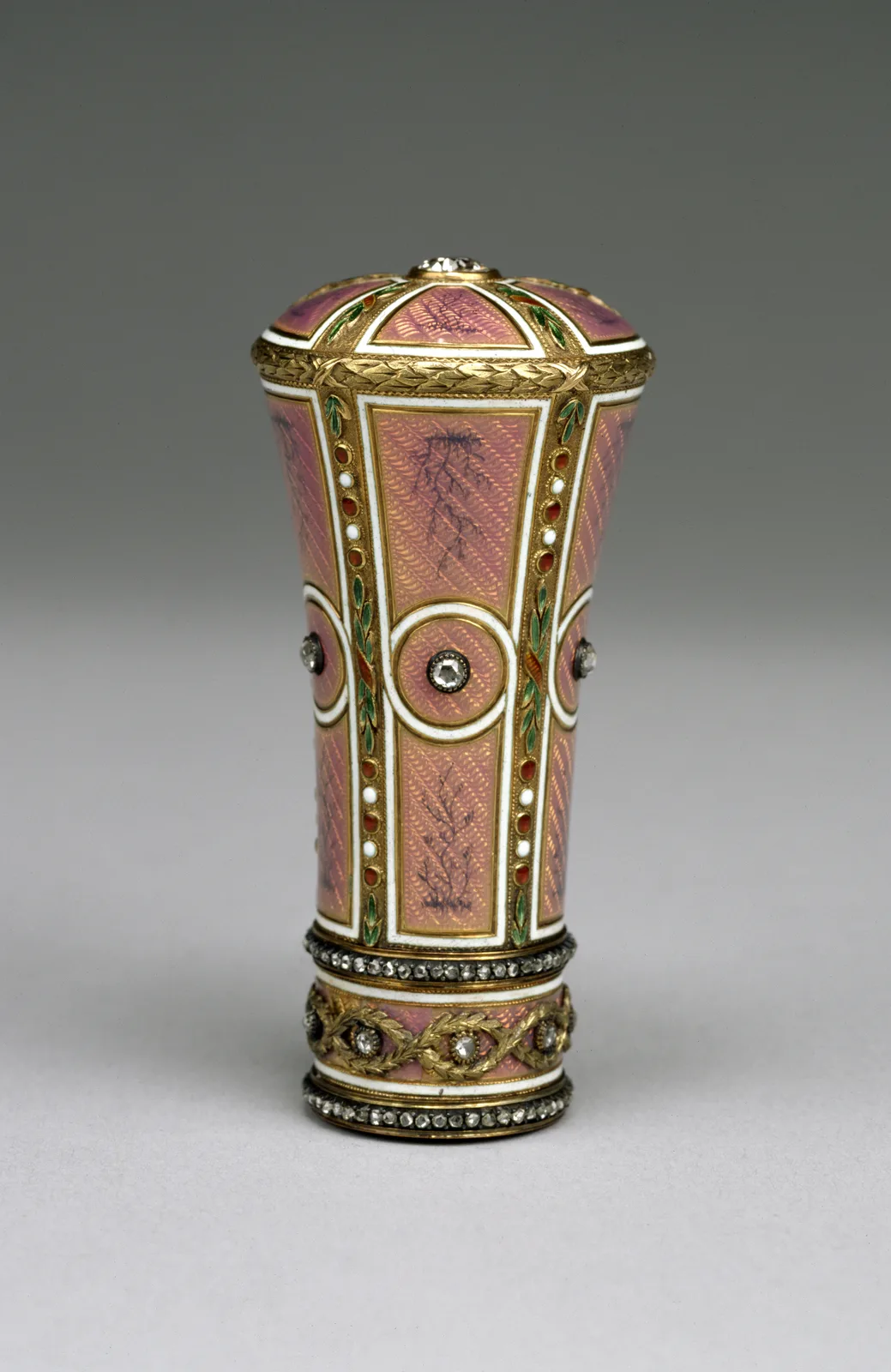 A Fabergé parasol handle of pink enamel over guilloché gold, with diamonds at the head