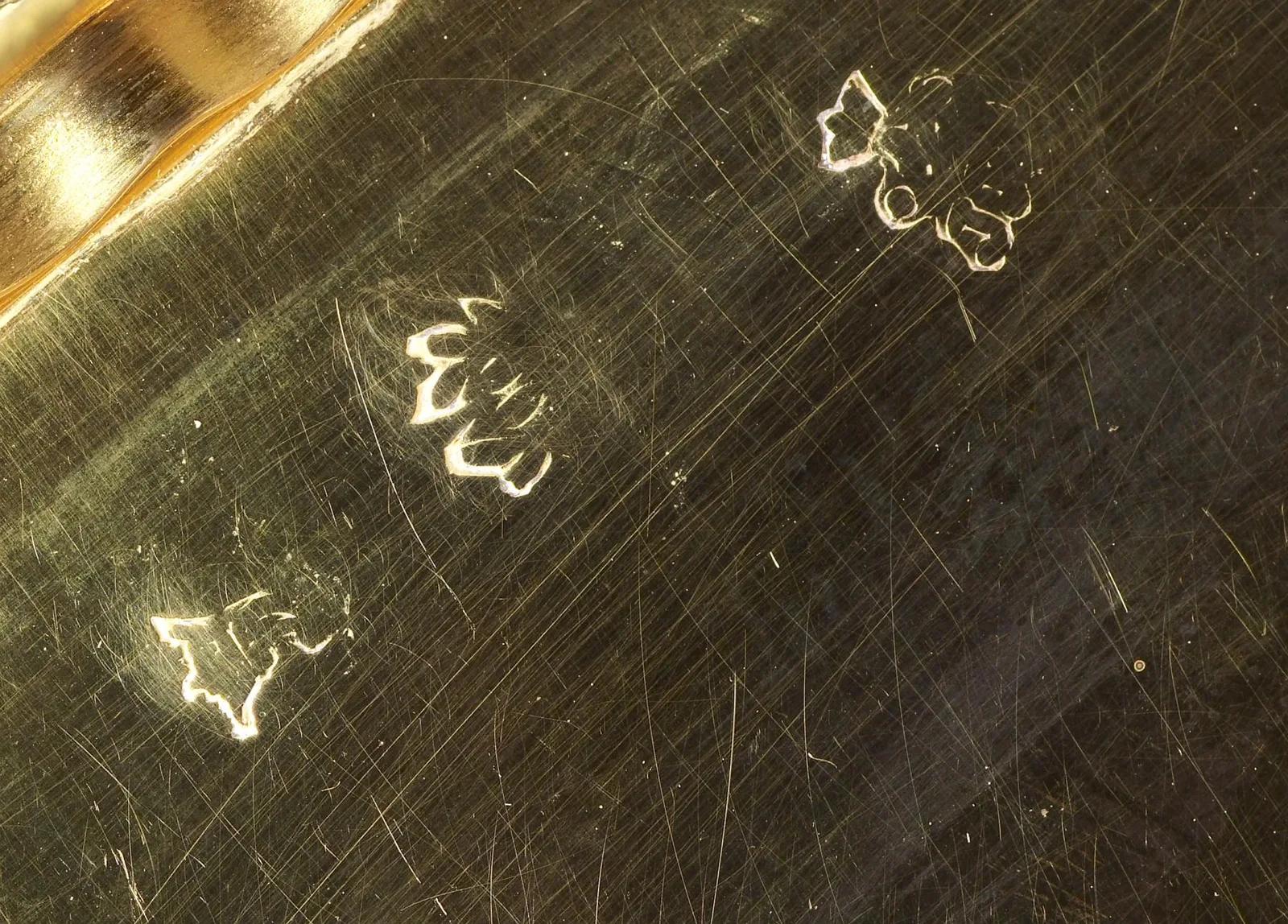 Close catalog still of three hallmarks punched into a polished gold field on an eighteenth-century Paris snuffbox