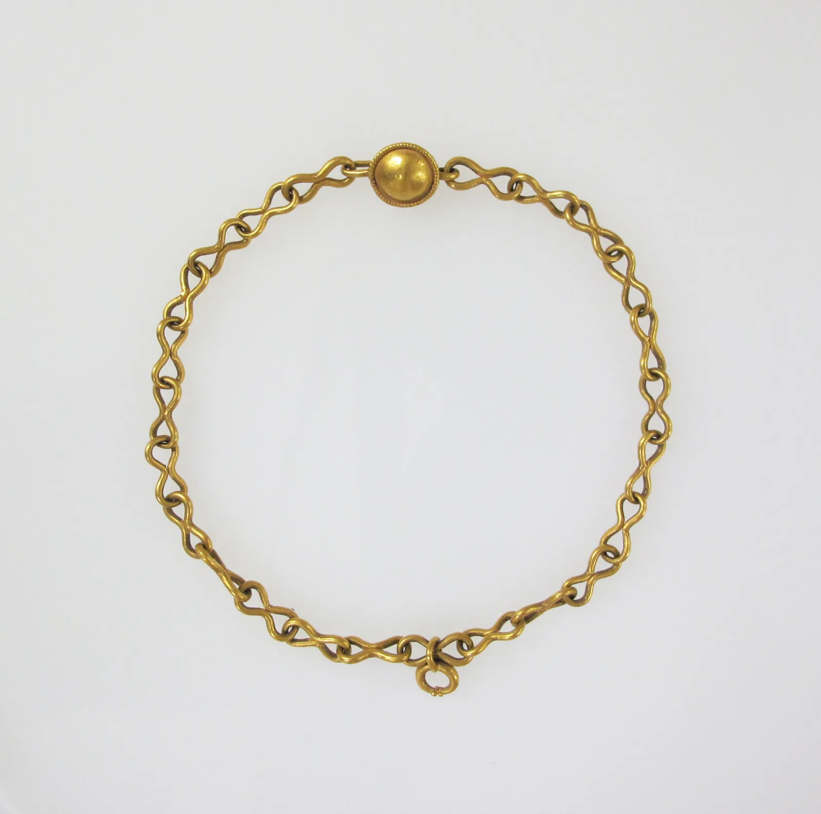 Roman gold necklace of open figure-eight links forming a circle, closed with a small gold ball clasp