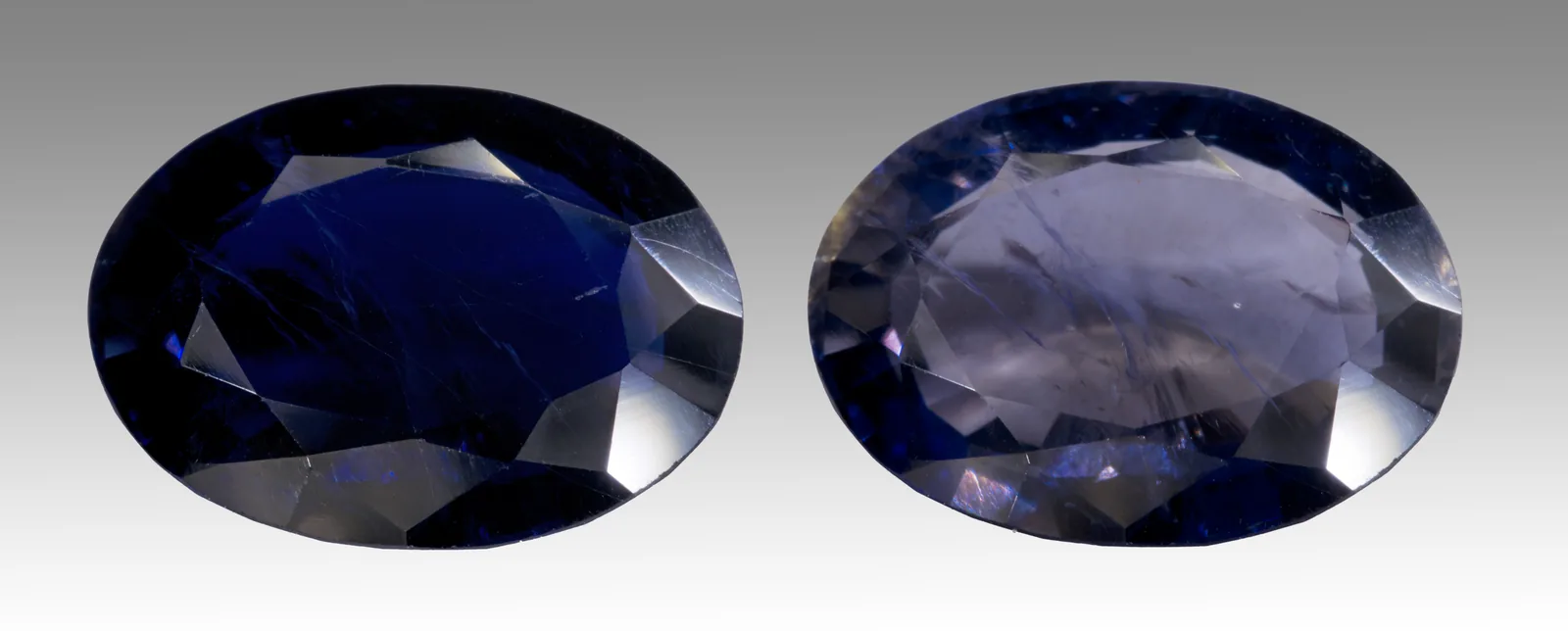 One cordierite crystal in two directions, a honey-gray beside a violet-blue, on a white ground