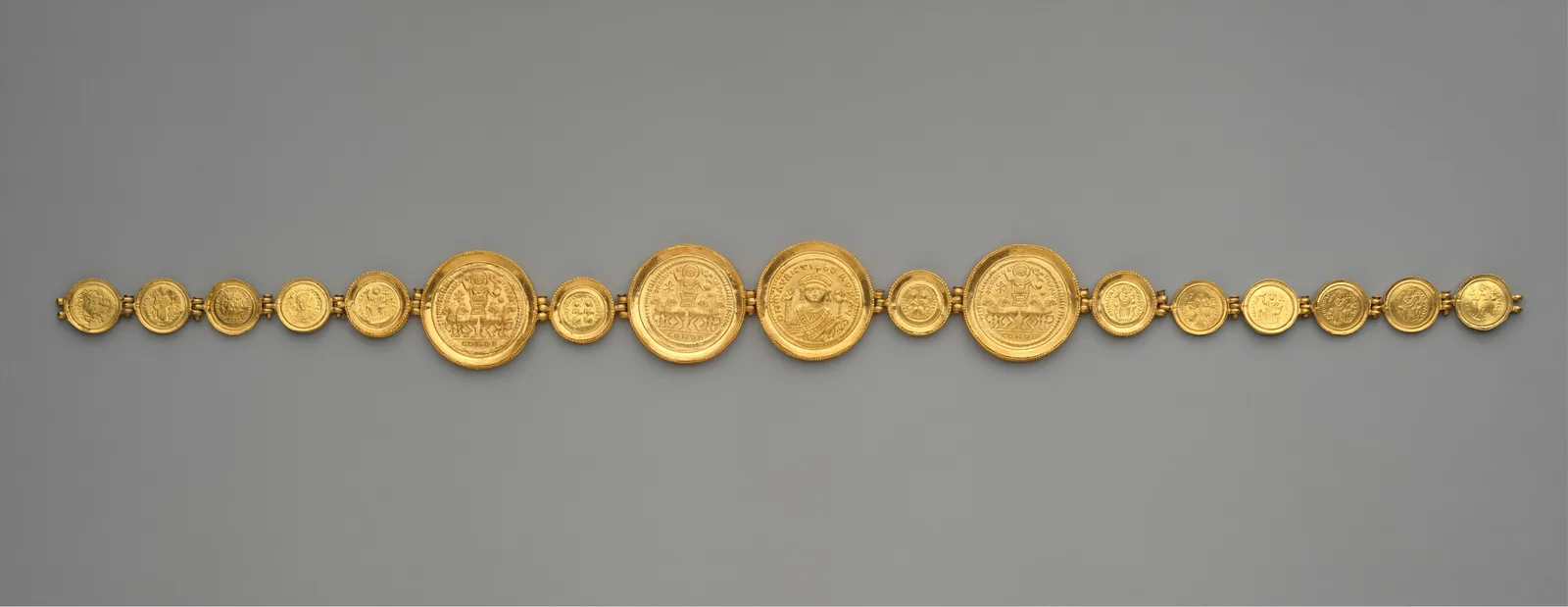 Byzantine gold girdle of linked medallions and stamped gold coins with imperial busts and chariot scenes