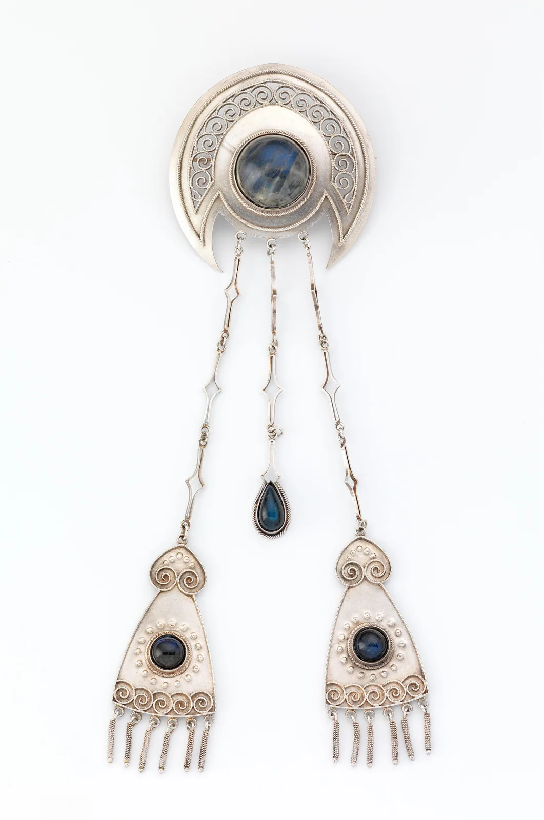 Art Nouveau silver brooch by Gustav Gaudernack with a labradorite center, museum catalog still on a light ground