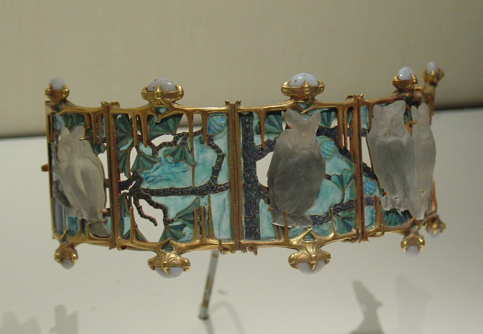 René Lalique hinged cuff with carved glass owls on gold branches and pale blue enamel