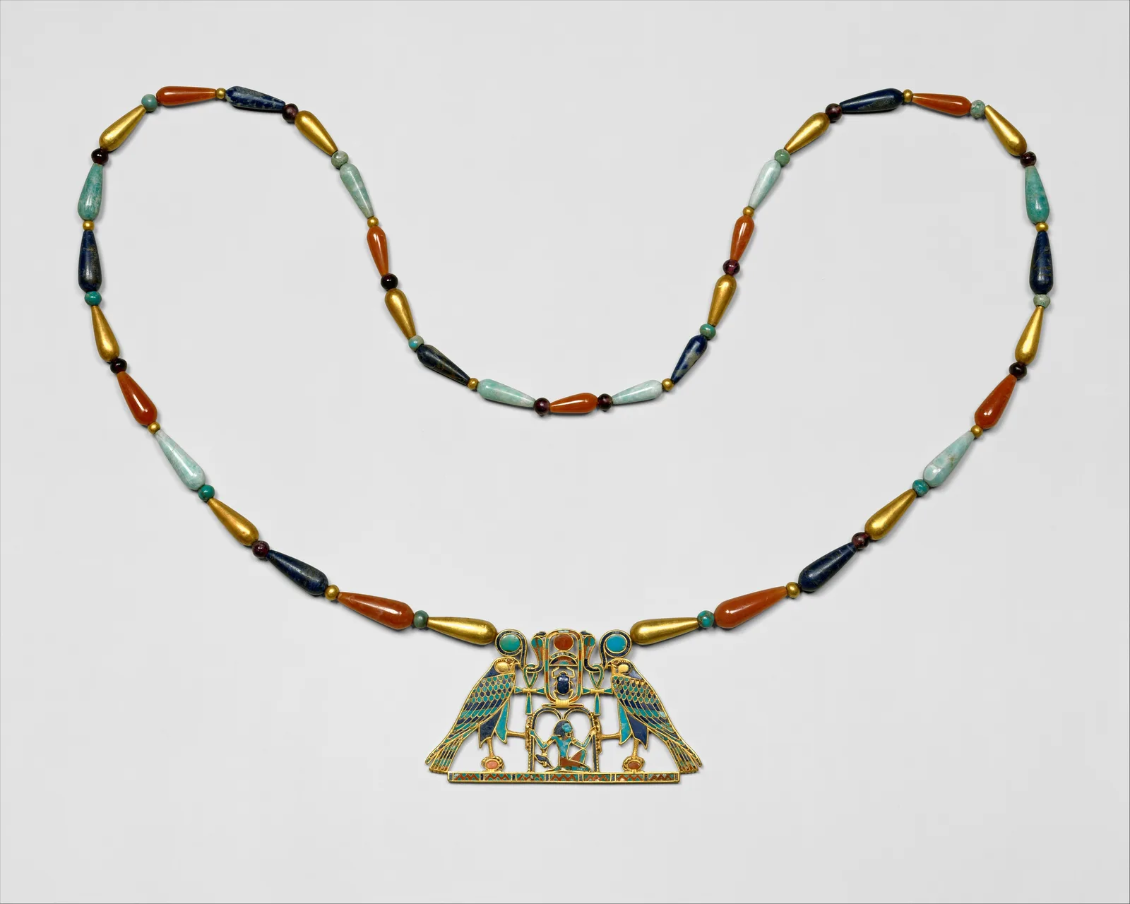 Middle Kingdom gold pectoral of Sithathoryunet with lapis falcons and a necklace of gold, lapis, carnelian, and turquoise drop beads