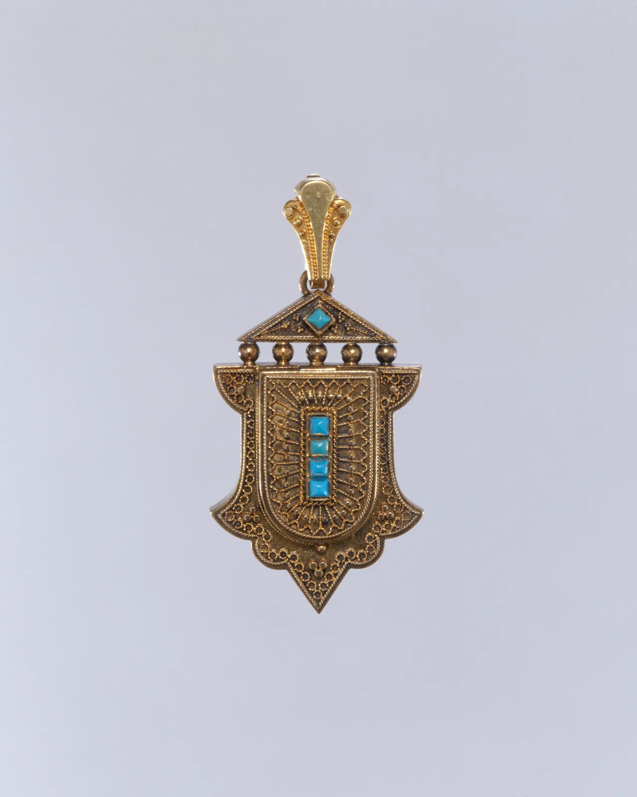 American gold locket shown open, a glass compartment holding a lock of hair, hinge along one side