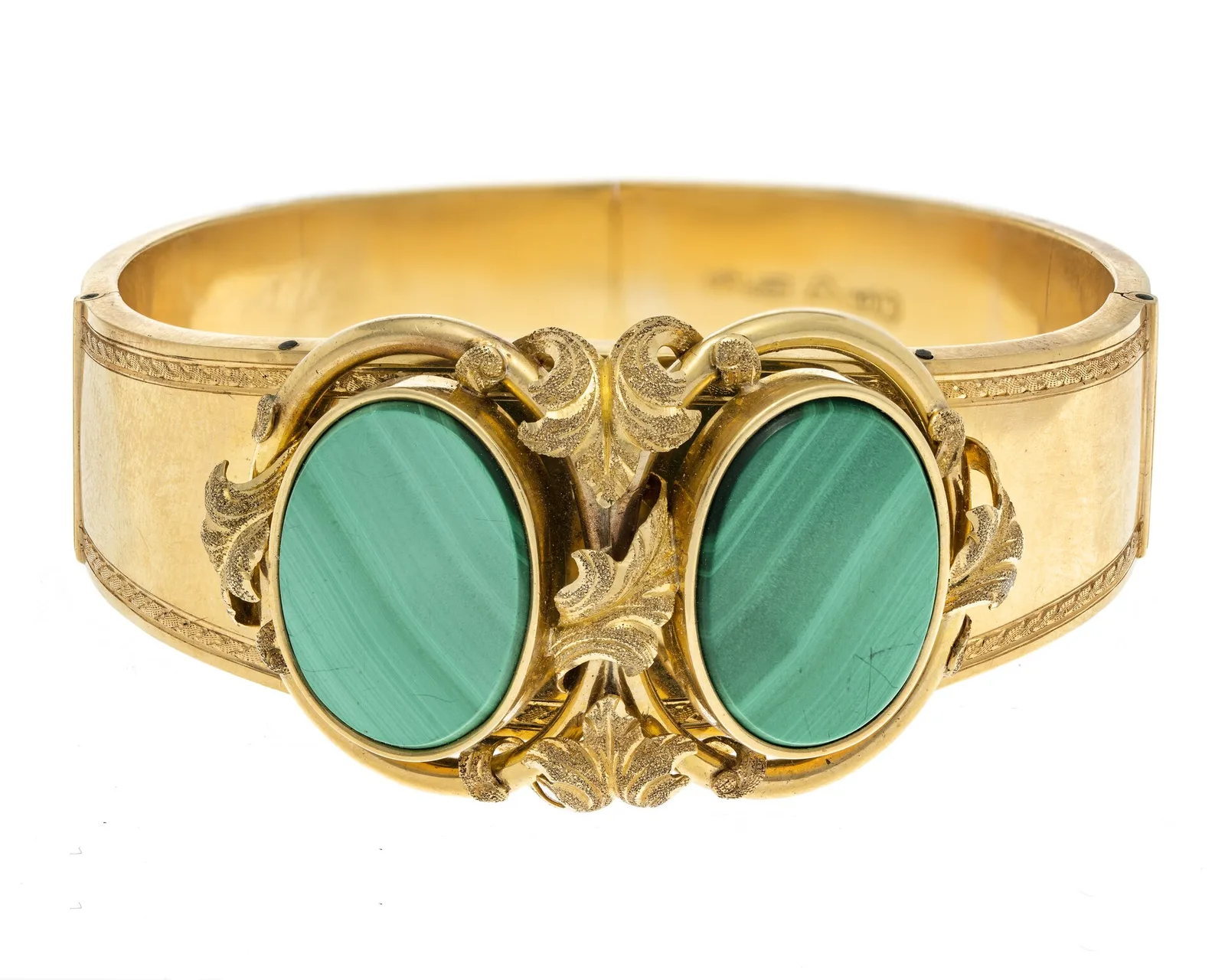 Wide nineteenth-century gold bangle with two oval malachite cabochons showing pale horizontal bands, oak-leaf gold between them