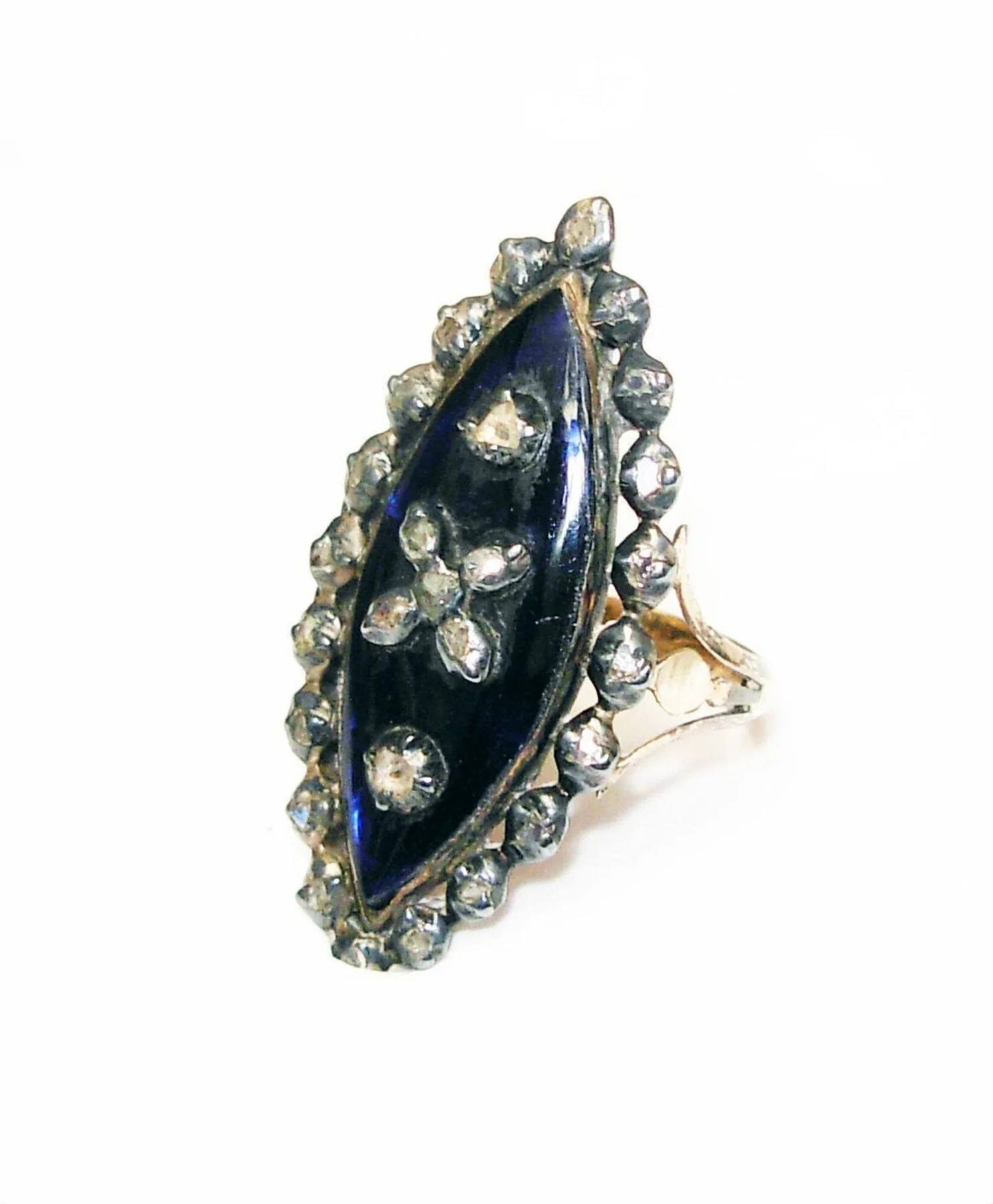 Gold ring with a shuttle-shaped marquise bezel of royal blue enamel bordered by diamonds, pointed at both ends like a boat