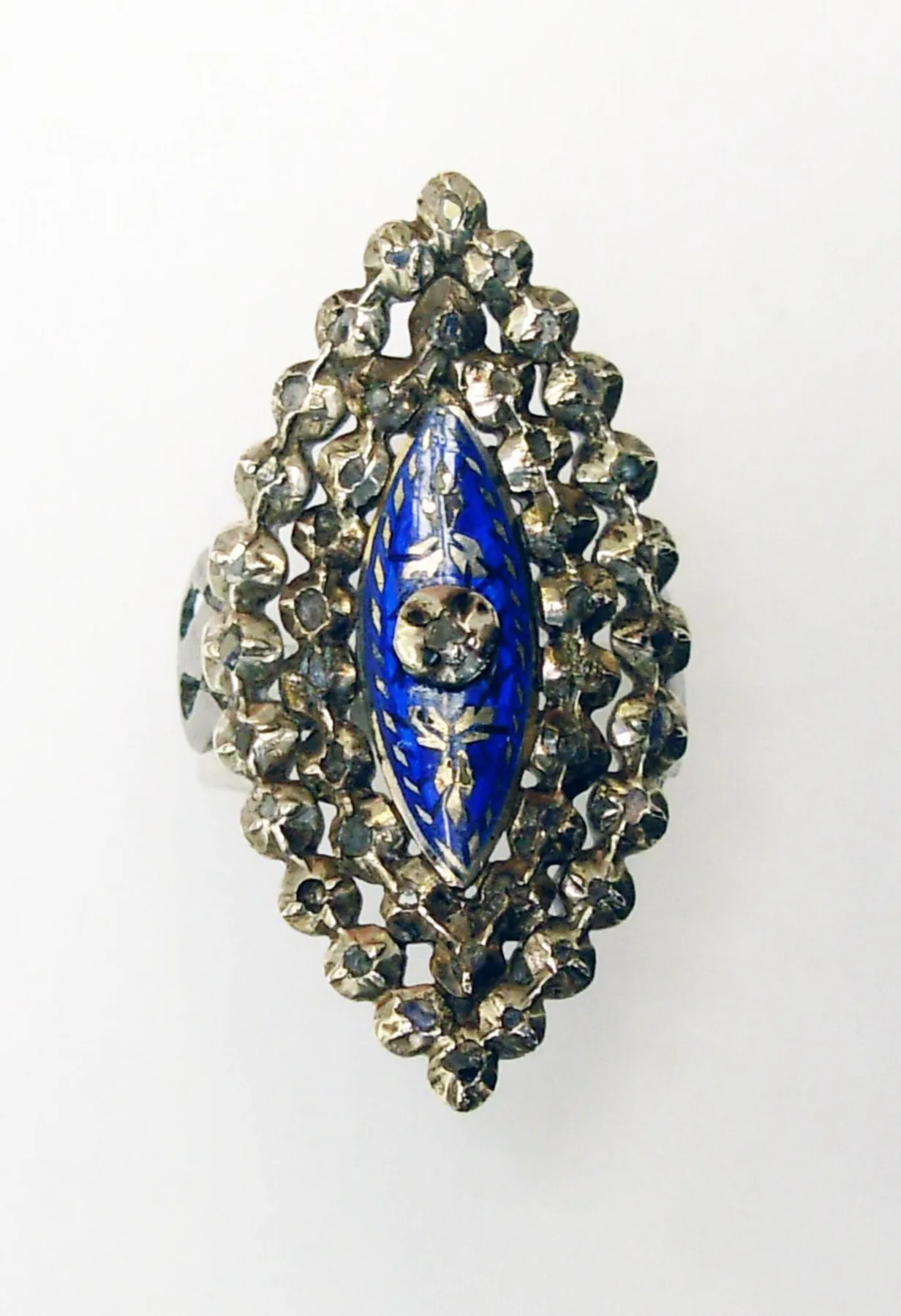 Silver navette ring with a slender boat-shaped blue enamel center, one diamond at the heart, and two borders of small diamonds