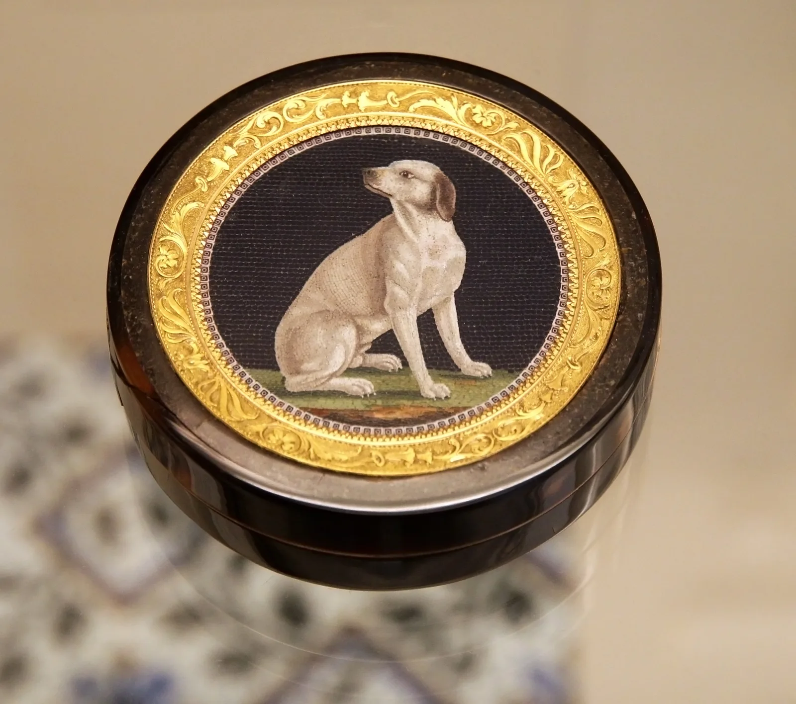 A glass micromosaic of a seated dog on a gold and tortoiseshell box, British Museum