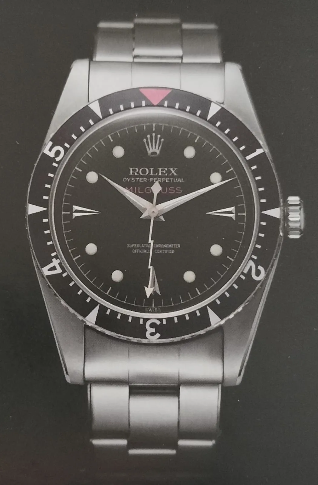 Rolex Milgauss ref. 6541 with a black honeycomb dial and an orange lightning seconds hand, shown off the wrist