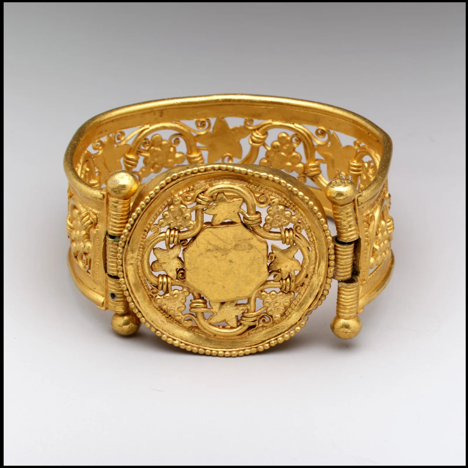 Byzantine gold cuff with an openwork grapevine band and a circular medallion bordered in beaded wire