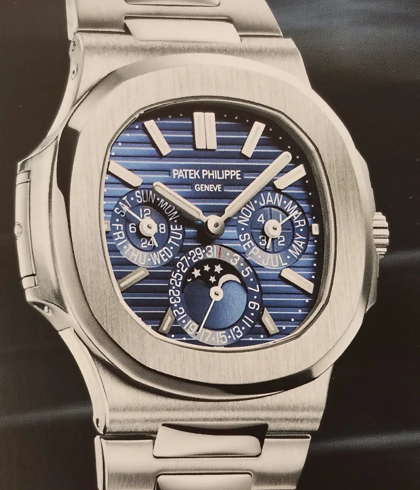 White-gold Patek Philippe Nautilus reference 5740 perpetual calendar with a rounded octagonal bezel and integrated bracelet, shown off the wrist