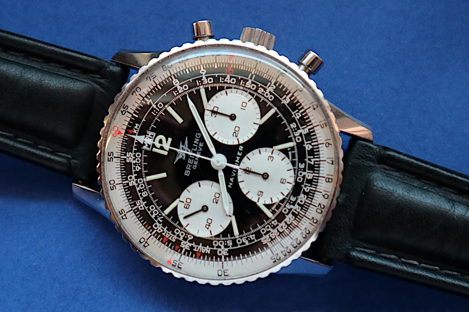 Breitling Navitimer 806 E, last version, case and bracelet on a blue ground, shown off the wrist