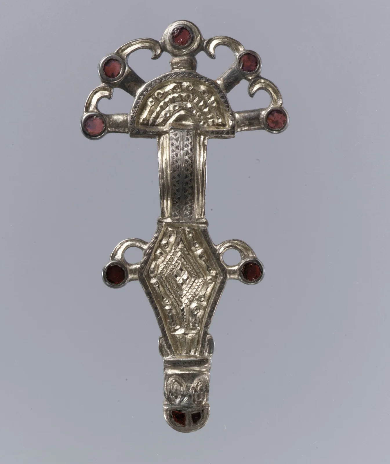 A second Frankish silver-gilt bow brooch with black niello borders and garnets set in the headplate