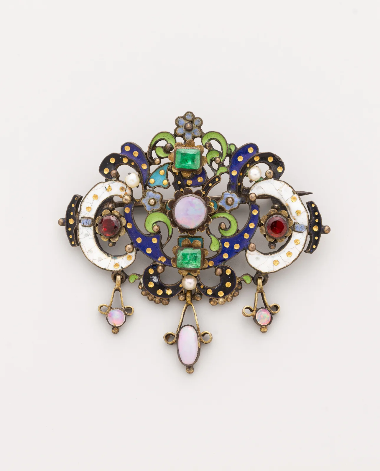 Nineteenth-century silver-gilt clasp with a central milky opal, enamel scrolls, and three hanging opal drops