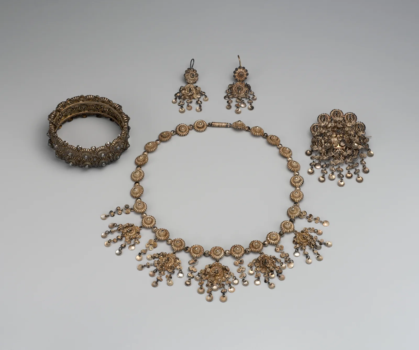A sixteen-piece silver filigree parure by Jacob Tostrup, the pieces laid together in one tray